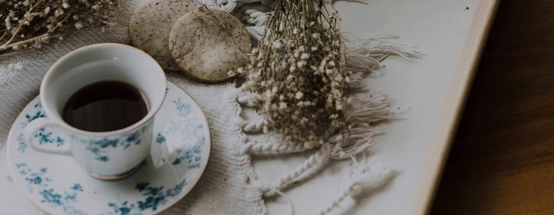tea and cookies on a serving tray with baby's breath
